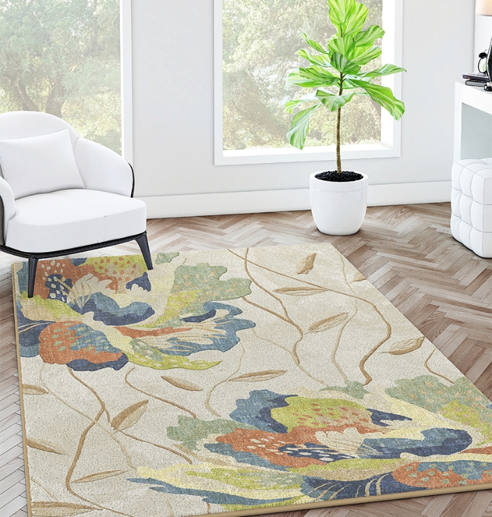 Bright room with floral rug, white chair, and potted plant on herringbone wood flooring.