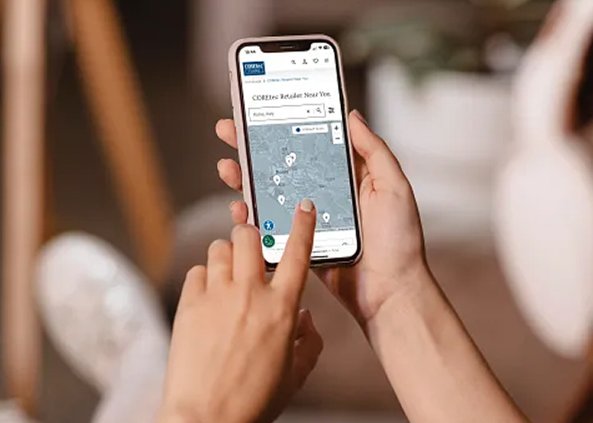Person using a smartphone to search for nearby retailers on a map.