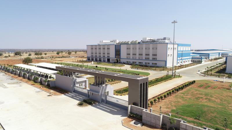 Large industrial facility with modern architecture and landscaped grounds.