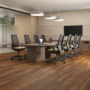 Modern home office with wood floors, large window, and built-in shelves.