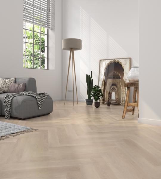 Cozy bedroom with neutral tones, a bed, vanity table, and cushioned stool on wood flooring.